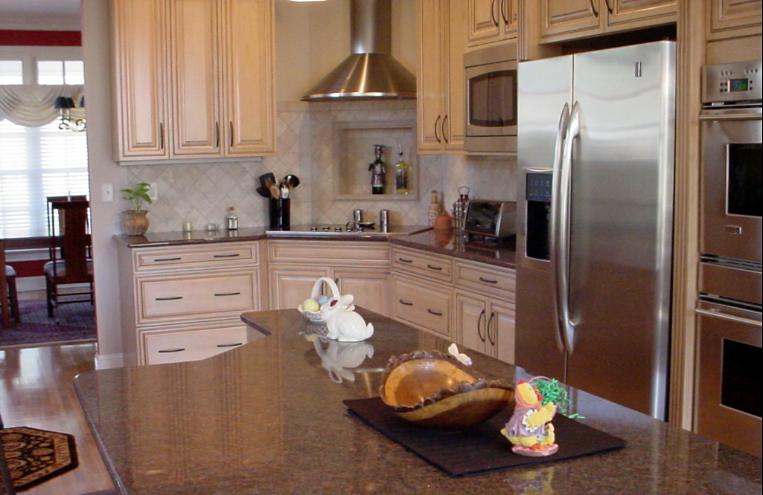 Renovated kitchen with a granite island, maple cabinets and stainless appliances