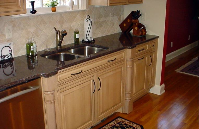 Sink run with granite counters and a tile backsplash