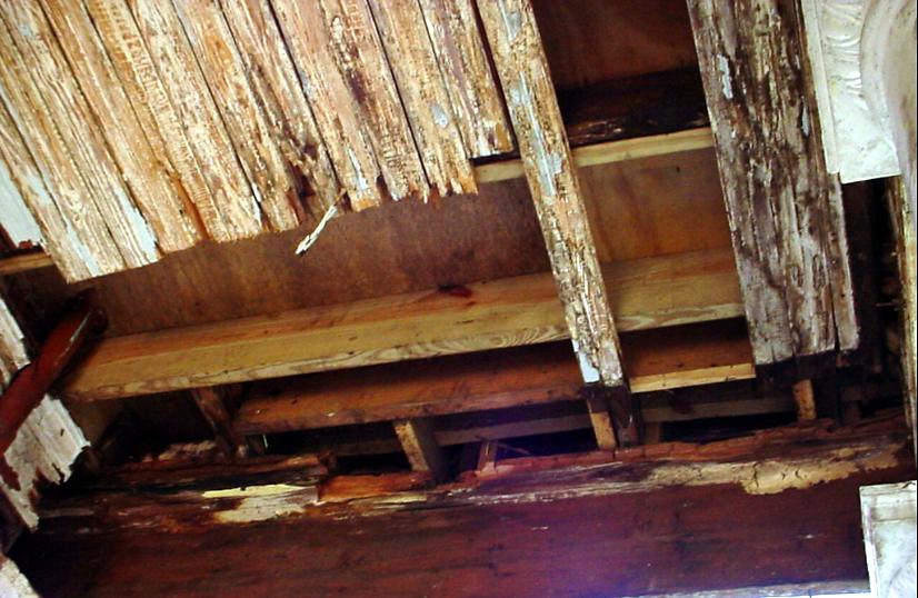 Rotted porch ceiling boards and framing, exposed during a restoration