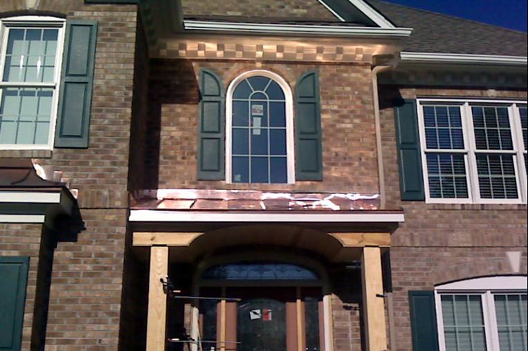 The portico under construction with its copper roof installed